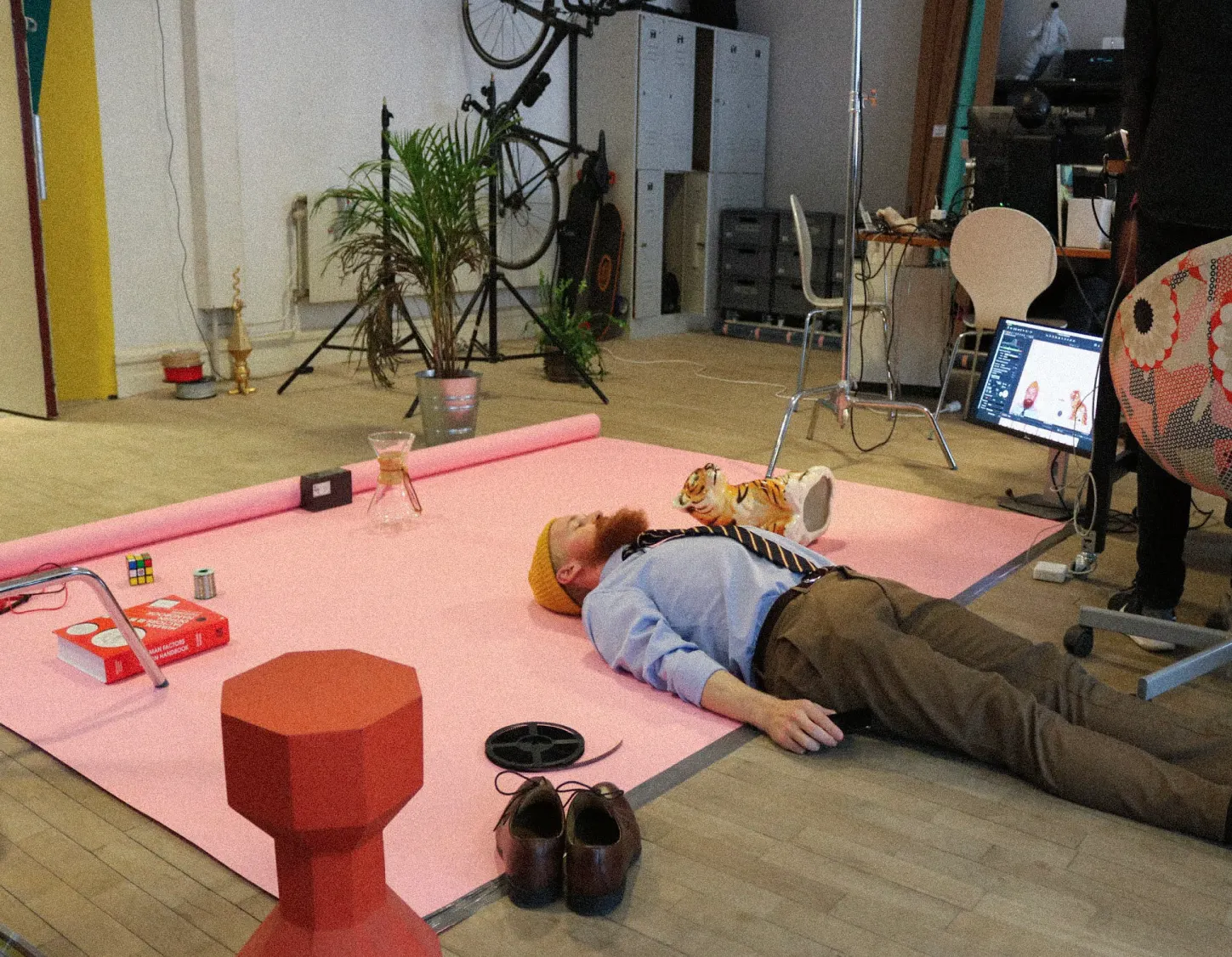 A man laying on the floor being creative