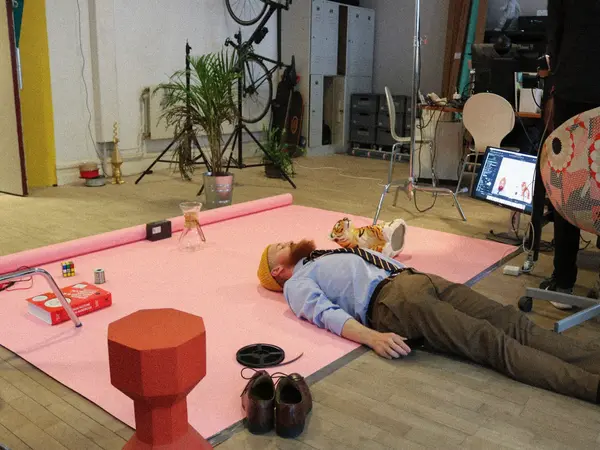 A man laying on the floor being creative